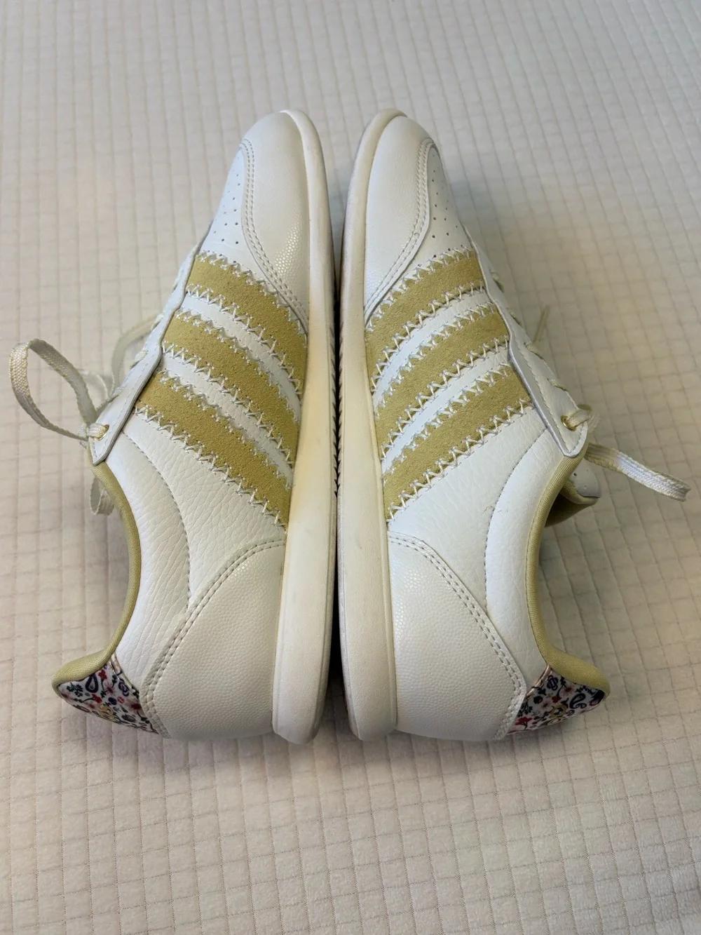 Adidas cream colored sneakers with floral accents